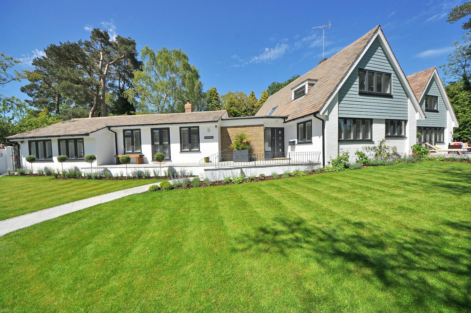 Modern Phoenix home with a flat synthetic-turf yard after a front-yard conversion.